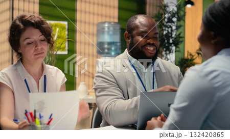 Diverse HR interviewers meeting with an applicant to review CV document, focusing on talent acquisition, work experience and qualifications for onboarding process in enterprise. 132420865