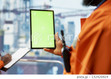 Isolated screen tablet used by offshore rig specialist monitoring operations on oil platform deck. Drilling rig employee reviewing energy operations using chroma key device, close up Isolated screen tablet used by offshore rig specialist monitoring operations on oil platform deck. Drilling rig employee reviewing energy operations using chroma key device, close up 132420924