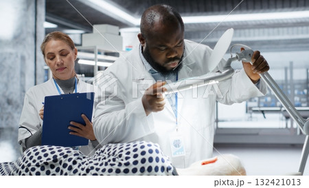 Professionals use magnifying glass to perform examination in a drug trial with patient, monitoring vitals and analyzing reactions. Studying dosage safety for biomedicine and toxicology. Camera B. Professionals use magnifying glass to perform examination in a drug trial with patient, monitoring vitals and analyzing reactions. Studying dosage safety for biomedicine and toxicology. Camera B. 132421013
