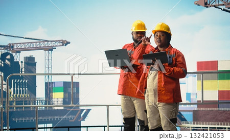 Offshore platform colleagues supervising deck operations with devices, ensuring compliance with safety protocols. Team of technicians doing equipment checkup on drilling rig, Offshore platform colleagues supervising deck operations with devices, ensuring compliance with safety protocols. Team of technicians doing equipment checkup on drilling rig, 132421053