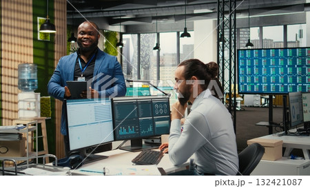 Corporate professional analyzes efficiency through charts and graphs to prepare monthly reports, utilizing strategic data insights to improve management practices in a modern office. 132421087