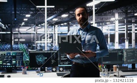 Data center manager presents AI technology to shareholders, demonstrating predictive maintenance capabilities. Man briefing investors on server hub artificial intelligence infrastructure, camera A 132421119