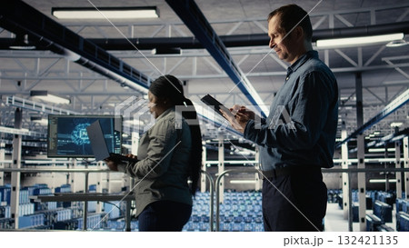 IT expert in server hub uses tablet to optimize deep learning AI systems handling tasks. Data center programmer adjusts artificial intelligence model parameters using device, camera A IT expert in server hub uses tablet to optimize deep learning AI systems handling tasks. Data center programmer adjusts artificial intelligence model parameters using device, camera A 132421135