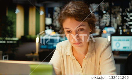 Discouraged woman creating plans and documenting objectives to share with executives during the next morning meeting. Employee drained in a mental haze doing overtime, pushing limits. Camera A. Discouraged woman creating plans and documenting objectives to share with executives during the next morning meeting. Employee drained in a mental haze doing overtime, pushing limits. Camera A. 132421266