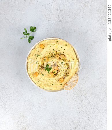 Lupin hummus or turmeric hummus with olive oil and herbs on a white background. Healthy vegan concept. 132421349