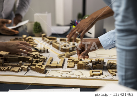 Team of real estate developers planning modern residential project, ensuring 3D models and market insights to prepare for site development and zoning regulations approval. Property investment. Team of real estate developers planning modern residential project, ensuring 3D models and market insights to prepare for site development and zoning regulations approval. Property investment. 132421462