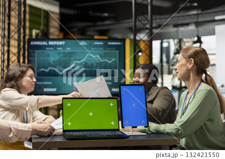 Group of business managers gathering near isolated copy space in work environment, perfect for custom organizational graphics, finance charts or analytics overlays for performance reports. 132421550
