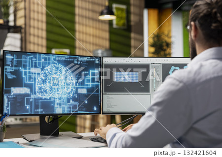 Technician in office working for renewable energy company using artificial intelligence to develop solar panels. Worker using AI tech to manufacture eco solar panel assembly workflows 132421604