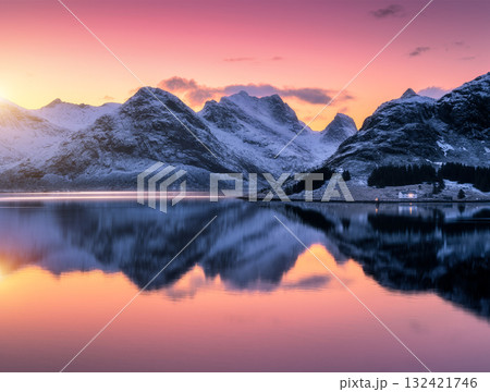 Colorful sunrise sky over snowy mountains reflecting in water Colorful sunrise sky over snowy mountains reflecting in water 132421746
