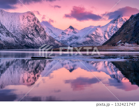 Pink sunrise, snowy mountains and houses reflecting in the water Pink sunrise, snowy mountains and houses reflecting in the water 132421747