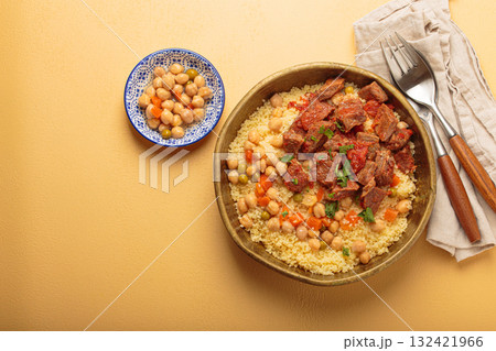 Moroccan couscous with tender meat and chickpea stew in rustic bow top view, Maghreb cuisine, space for text 132421966