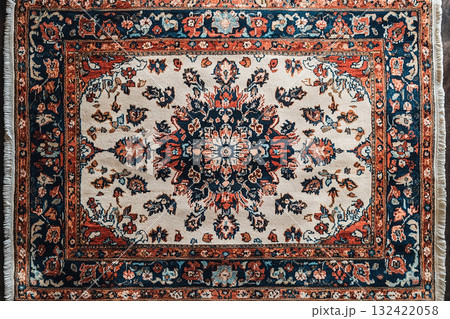 Handwoven Persian rug texture on a white background. Top view. 132422058