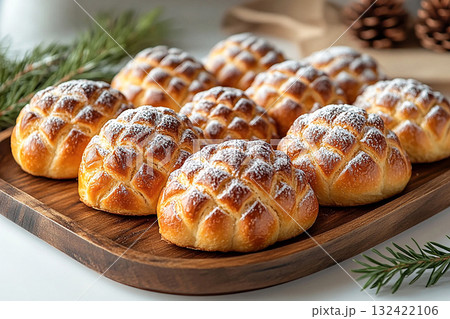 Homemade vibe. Christmas buns in the shape of a pine cone in on a wooden trading tray on a white background. 132422106