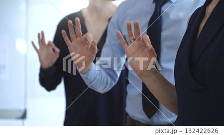 Business professionals showing ok hand gestures during a seminar, symbolizing agreement, teamwork, success, and positive communication in a corporate meeting setting 132422626