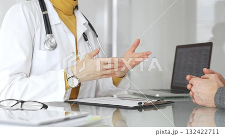 Doctor writing prescription during patient consultation in clinic, providing medical care and diagnosis. Medicine, healthcare and science concept Doctor writing prescription during patient consultation in clinic, providing medical care and diagnosis. Medicine, healthcare and science concept 132422711