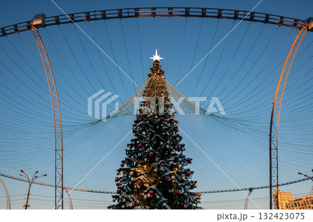 Christmas tree and New Year decorations on the town square on a frosty winter day. Christmas tree and New Year decorations on the town square on a frosty winter day. 132423075