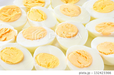 A close up of hard boiled chicken eggs. boiled chicken eggs peeled and cut in half close up. 132423366