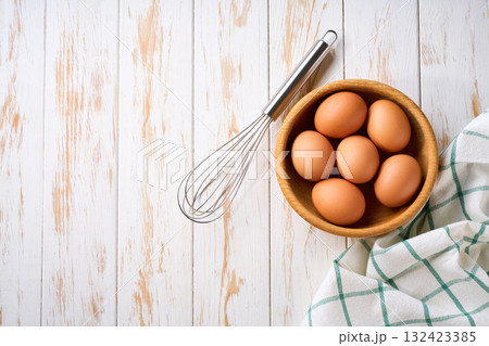 natural organic chicken eggs in a bowl on a light kitchen table, top view. natural organic chicken eggs in a bowl on a light kitchen table, top view. 132423385
