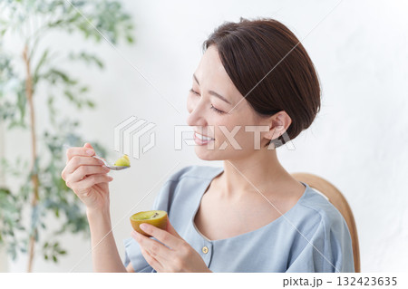 キウイフルーツを食べる女性 132423635