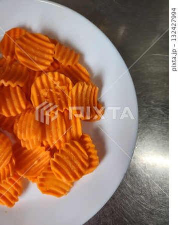 Orange Swirled Carrot Chips On White Plate For Healthy Snack Photography 132427994