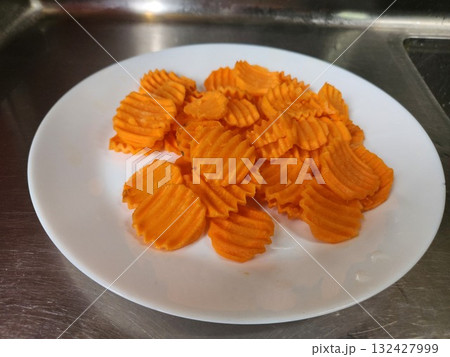 Orange Swirled Carrot Chips On White Plate For Healthy Snack Photography Orange Swirled Carrot Chips On White Plate For Healthy Snack Photography 132427999