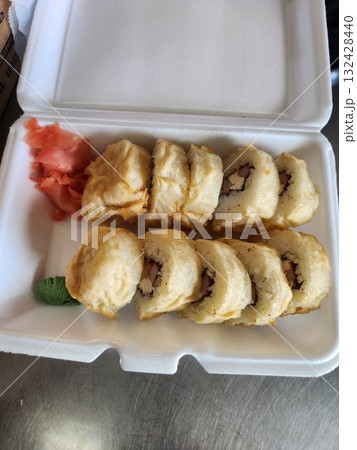 Delicious Sushi Rolls With Drizzled Sauce, Pickled Ginger, and Wasabi in Takeout Box Delicious Sushi Rolls With Drizzled Sauce, Pickled Ginger, and Wasabi in Takeout Box 132428440