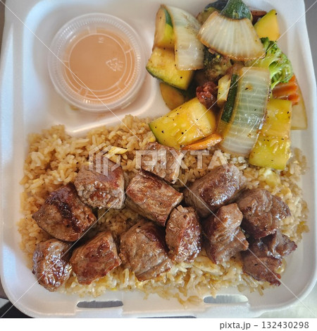 Assorted Grilled Meats, Shrimp, Vegetables, and Rice in Takeout Container with Sweet Sauce Assorted Grilled Meats, Shrimp, Vegetables, and Rice in Takeout Container with Sweet Sauce 132430298