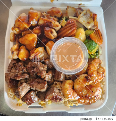 Assorted Grilled Meats, Shrimp, Vegetables, and Rice in Takeout Container with Sweet Sauce 132430305