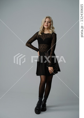 Stylish young woman poses confidently in a trendy outfit with elegant accessories Stylish young woman poses confidently in a trendy outfit with elegant accessories 132430685