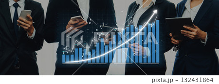 Dynamic Business Professionals Analyzing Data with Smartphones and Tablets in Front of Growing Graph and Financial Metrics on a Modern Background Axiom Dynamic Business Professionals Analyzing Data with Smartphones and Tablets in Front of Growing Graph and Financial Metrics on a Modern Background Axiom 132431864