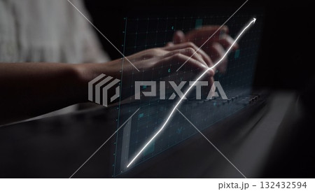 Hands Typing on Keyboard with Digital Chart Showing Growth and Progress in Dark Setting for Business and Technology Concepts Copula 132432594