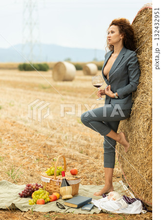 Portrait of female manager with glass of red wine on farm field Portrait of female manager with glass of red wine on farm field 132432951