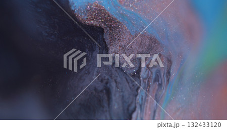 Blur ripple ink. Wet texture. Defocused orange purple blue color glitter chemical blotch floating on abstract dark black bokeh background. 132433120