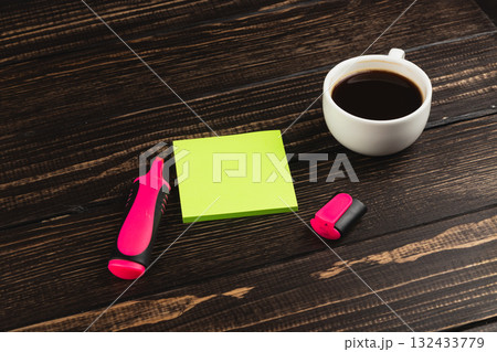 Coffee, stationery, and workspace setup for productivity on a wooden table 132433779