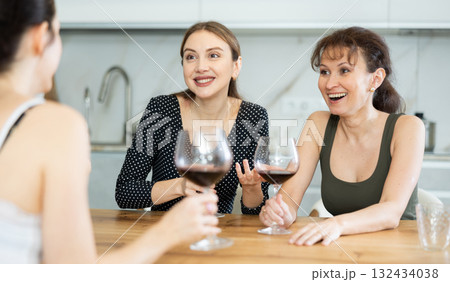 Three women have nice chat-in with wine and conversation 132434038