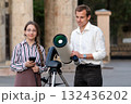 Man and girl with telescope preparing for observation 132436202