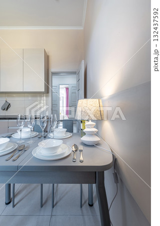 Bright Modern Kitchen with Table Setting and Lamp Light Bright Modern Kitchen with Table Setting and Lamp Light 132437592