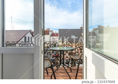 Elegant Balcony with Wine and Scenic European Rooftops 132437609