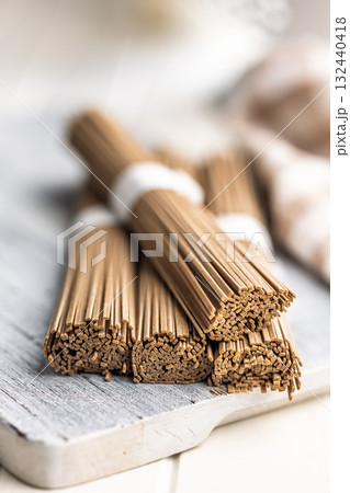 Buckwheat soba noodles on white table. 132440418