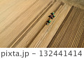 Aerial View of Tractors Preparing Farmland for Planting Season 132441414