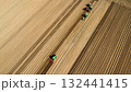 Aerial View of Tractors Preparing Farmland for Planting Season 132441415