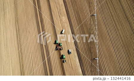 Aerial View of Tractors Preparing Farmland for Planting Season Aerial View of Tractors Preparing Farmland for Planting Season 132441416