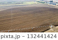 Aerial View of Tractors Preparing Farmland for Planting Season 132441424