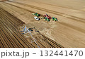 Aerial View of Tractors Preparing Farmland for Planting Season 132441470