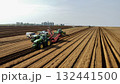 Aerial View of Tractors Preparing Farmland for Planting Season 132441500