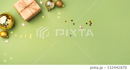Christmas gift with ornaments on a green background Christmas gift with ornaments on a green background 132442870