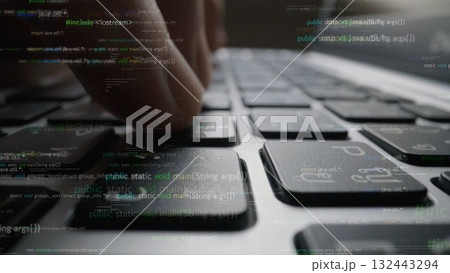 Close-Up View of a Hand Typing on a Laptop Keyboard Amidst Lines of Code and Digital Data, Symbolizing Technology and Innovation in Programming xenic 132443294