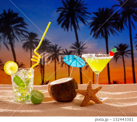 beach cocktail sunset on palm tree sand mojito margarita 132443381