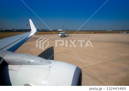 Airplane wing in airport with aircraft background 132443469