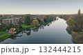 London, Teddington: Calm River Thames flowing through Teddington district in London city, reflecting trees and houses on a peaceful autumn morning. Drone flight London, Teddington: Calm River Thames flowing through Teddington district in London city, reflecting trees and houses on a peaceful autumn morning. Drone flight 132444215
